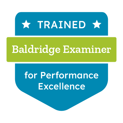 badge that reads Trained Baldridge Examiner for Performance Excellence