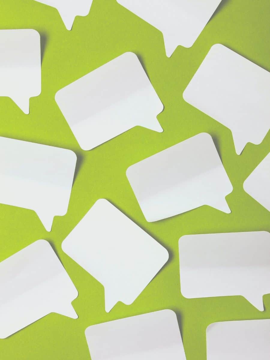 paper speech bubbles on a green background